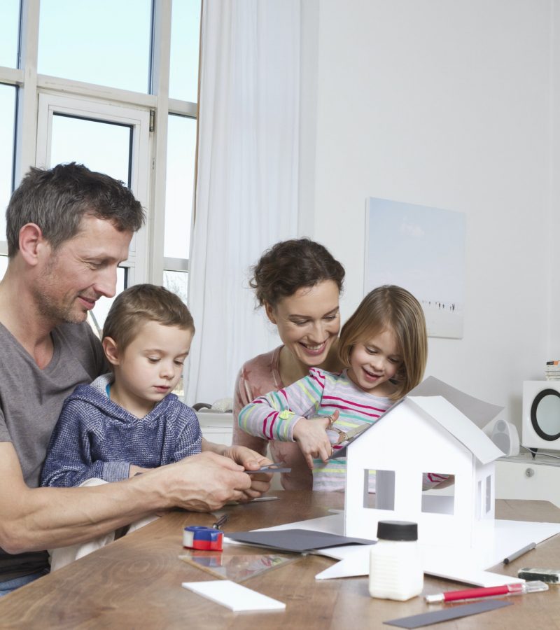 Family of four constructing house model